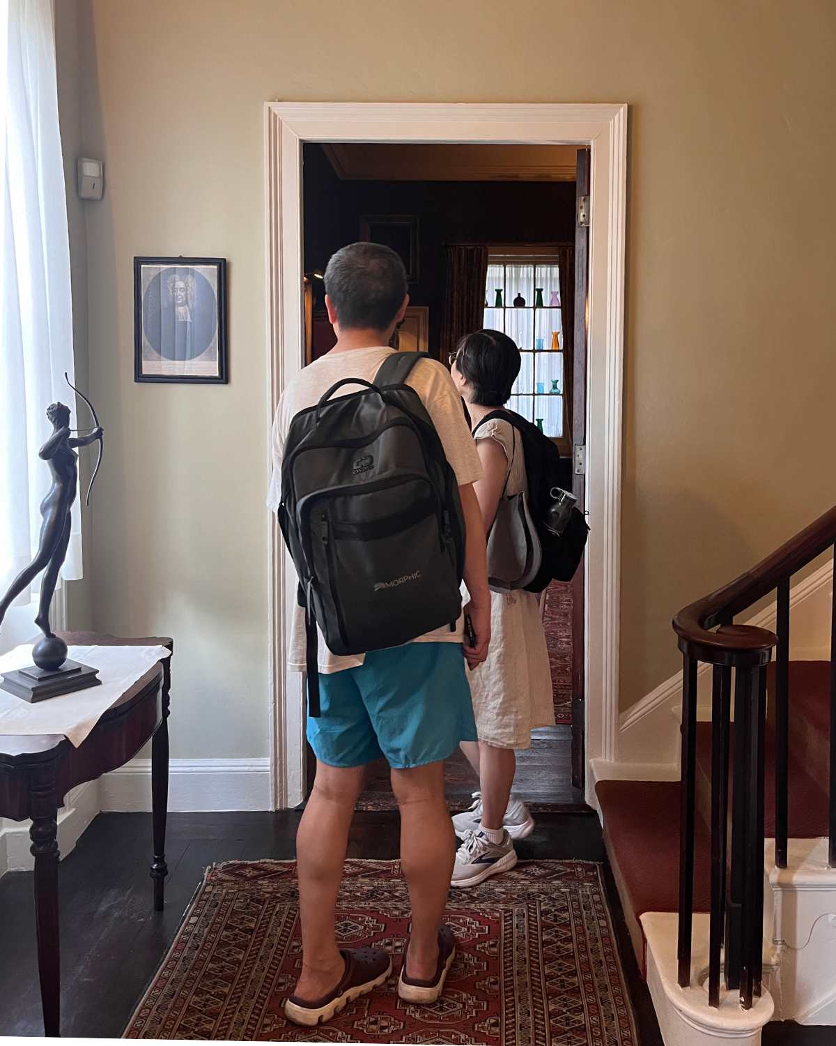 A man and a woman explore the second floor hallway